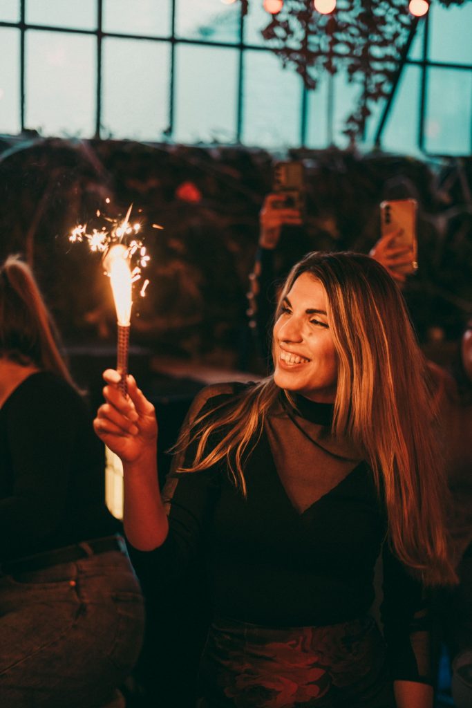Guest smiling with a sparkler